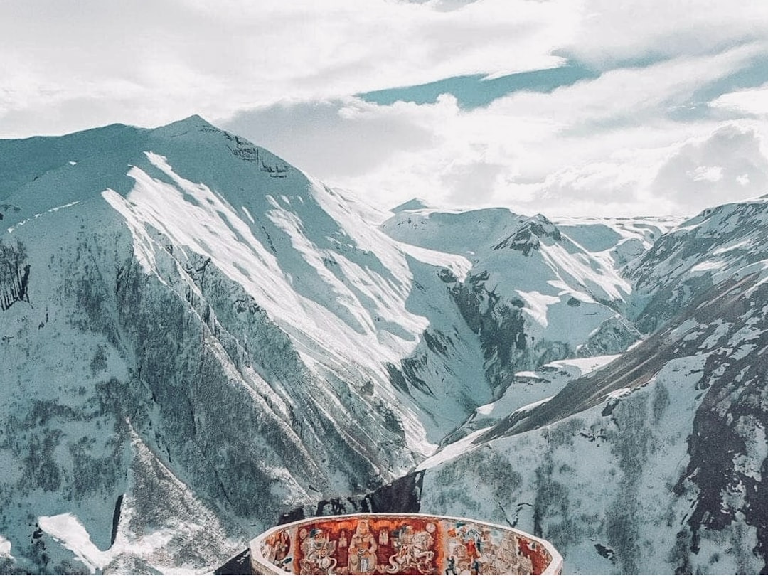a person holding a world famous Pikes Peak donut with the mountain view behind them