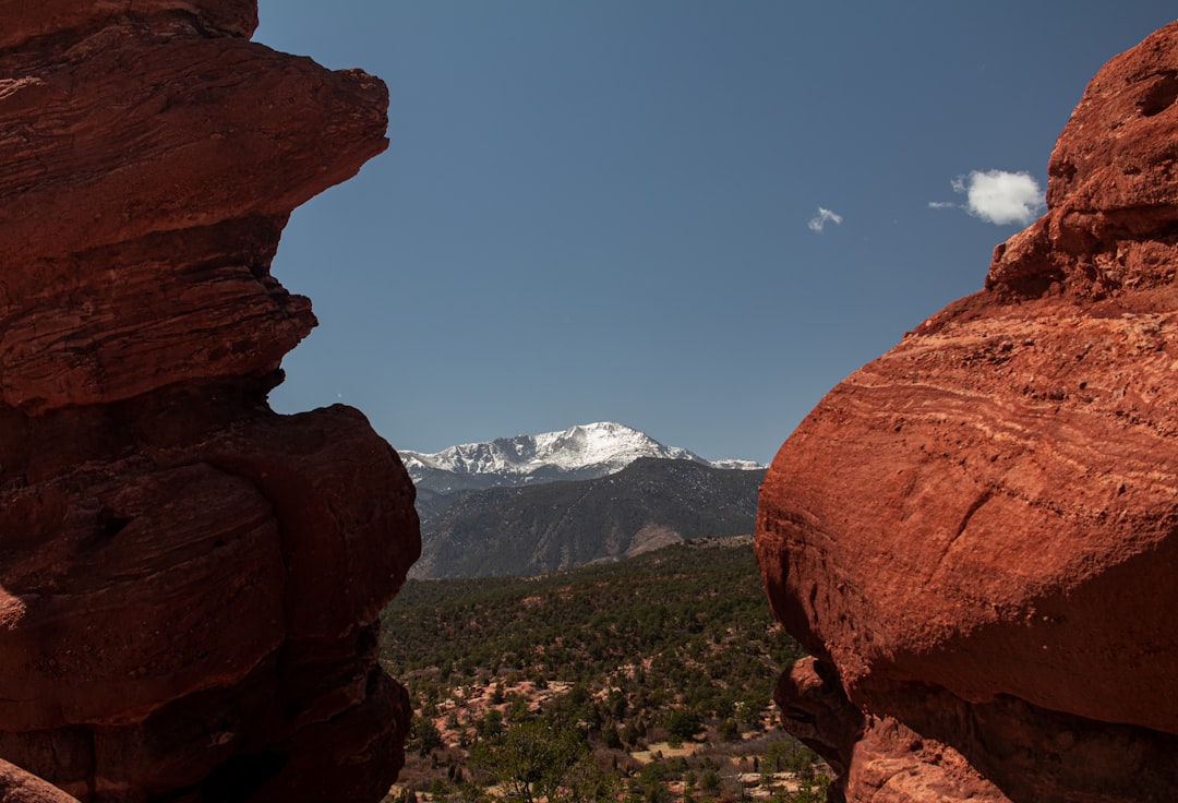 Garden of the Gods red rock formations at sunrise with Pikes Peak in the background