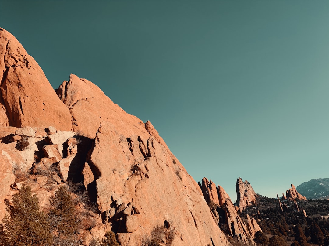hiker looking at stunning red rock formations in Garden of the Gods Colorado at sunrise