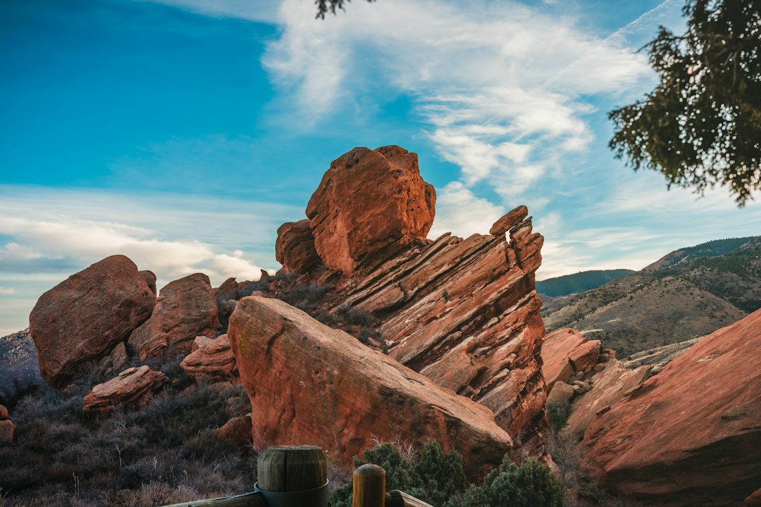 hiker looking up at red rock formations in Garden of the Gods at sunrise