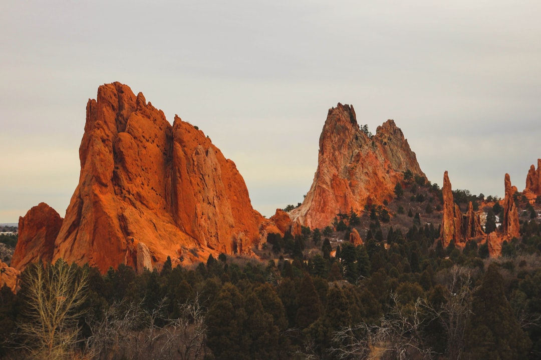 Hikers watching the sunrise over Garden of the Gods red rocks