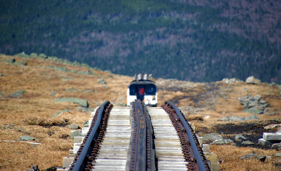 red Pikes Peak Cog Railway train climbing a steep mountain track