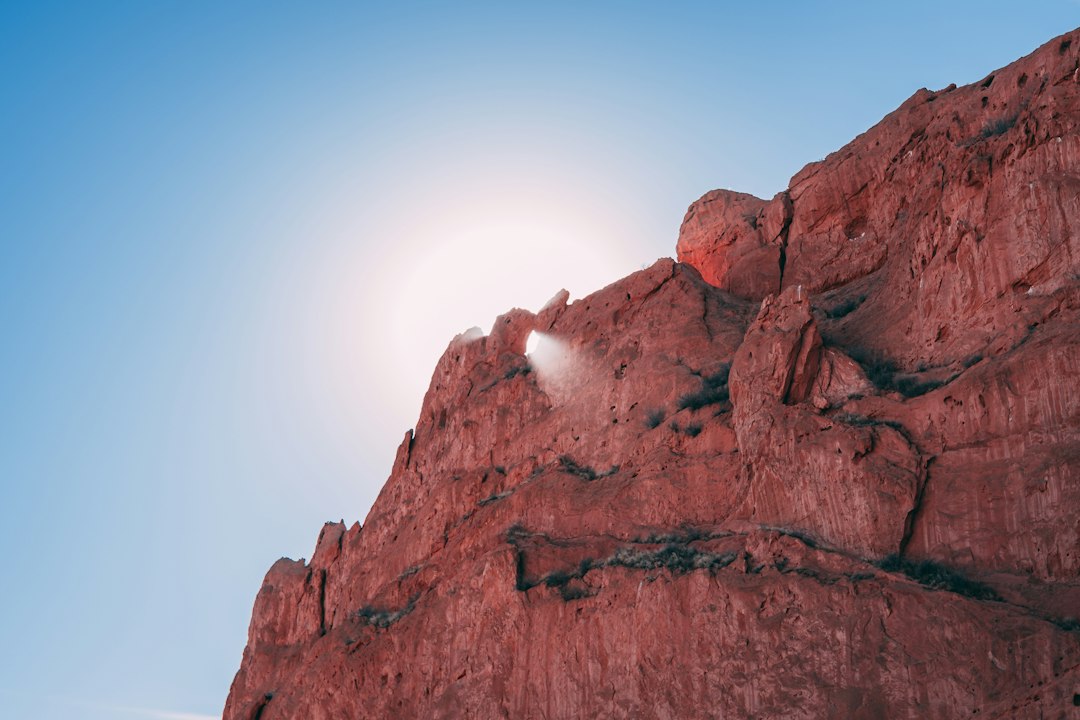 sunrise casting long shadows on Garden of the Gods red rock formations