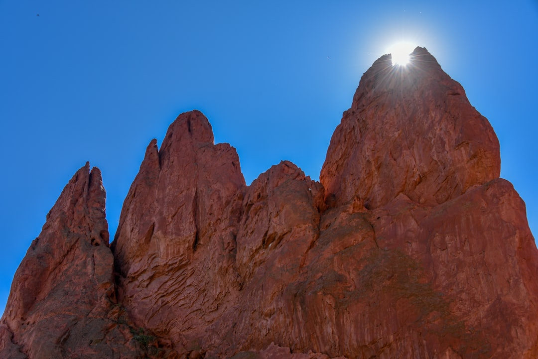 Towering red rock formations in Garden of the Gods under a bright blue sky