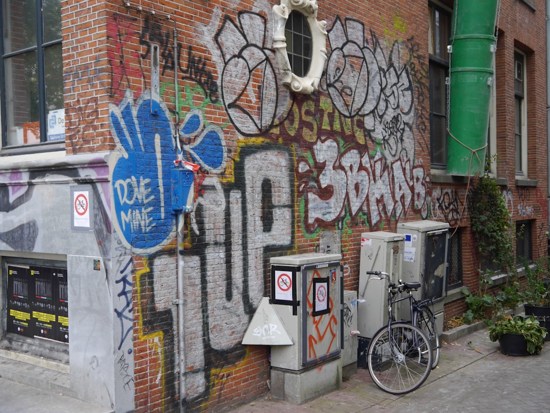 a colorful graffiti mural on an urban brick wall
