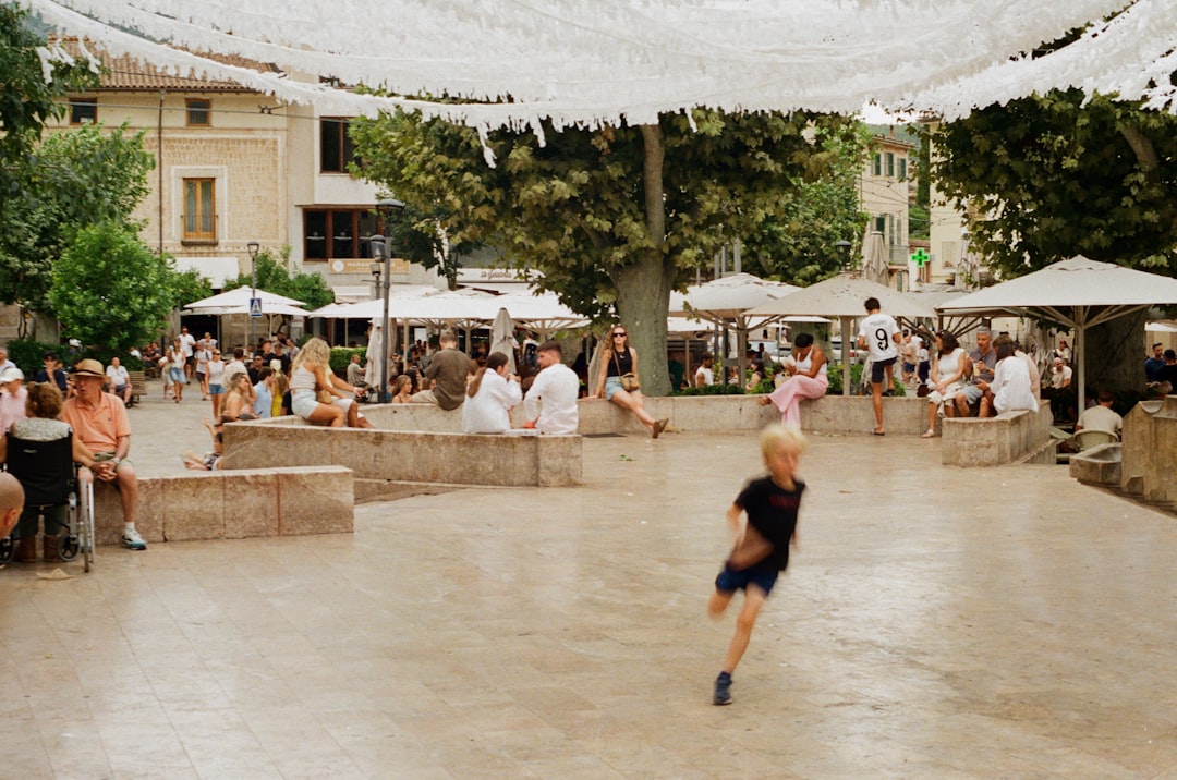 charming town square with farmers market stalls under oak trees