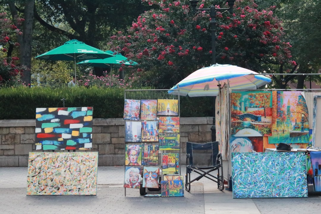 local artists displaying paintings and crafts at an outdoor evening art walk