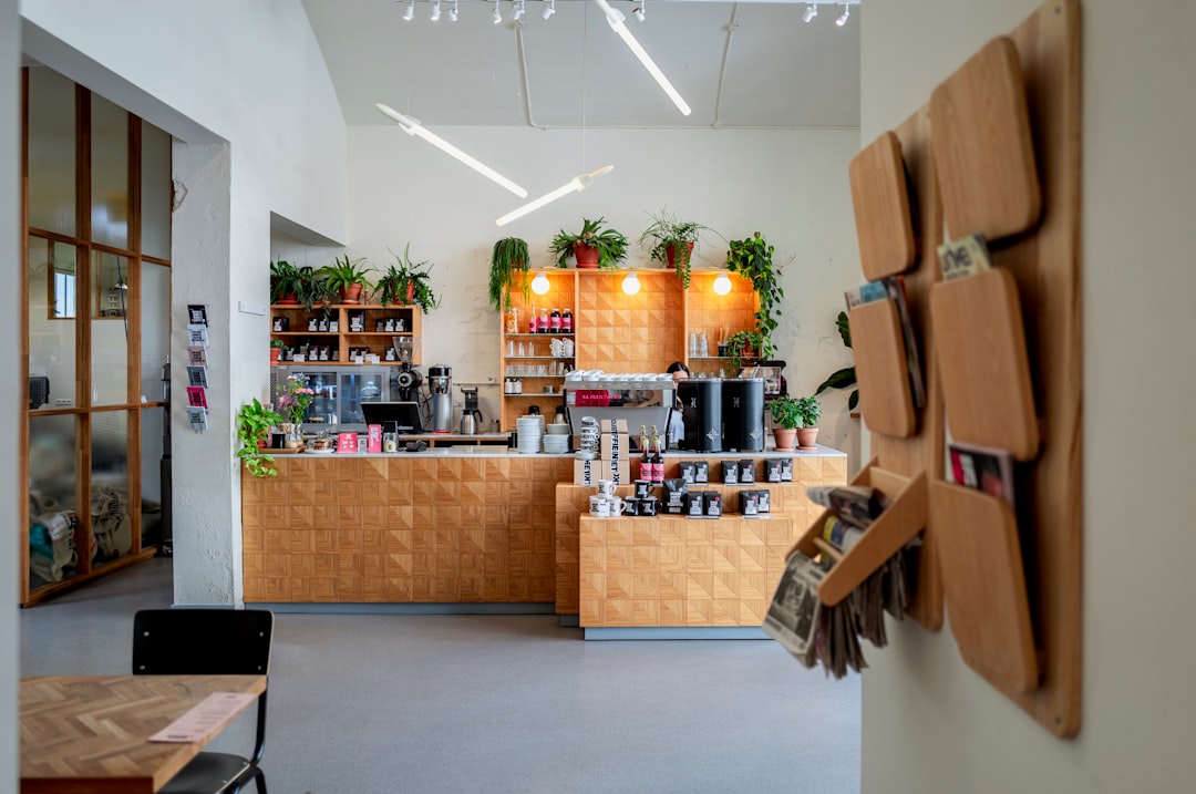 modern coffee shop interior with plants and local art