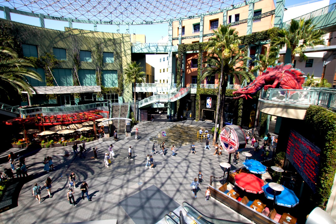 modern outdoor shopping center with families walking and palm trees