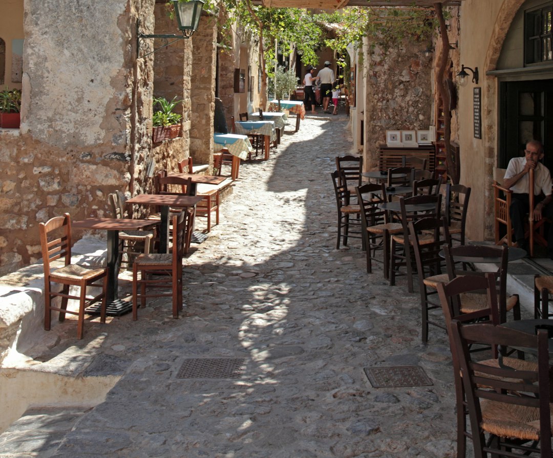 quaint cobblestone street in a village with cafes and shops