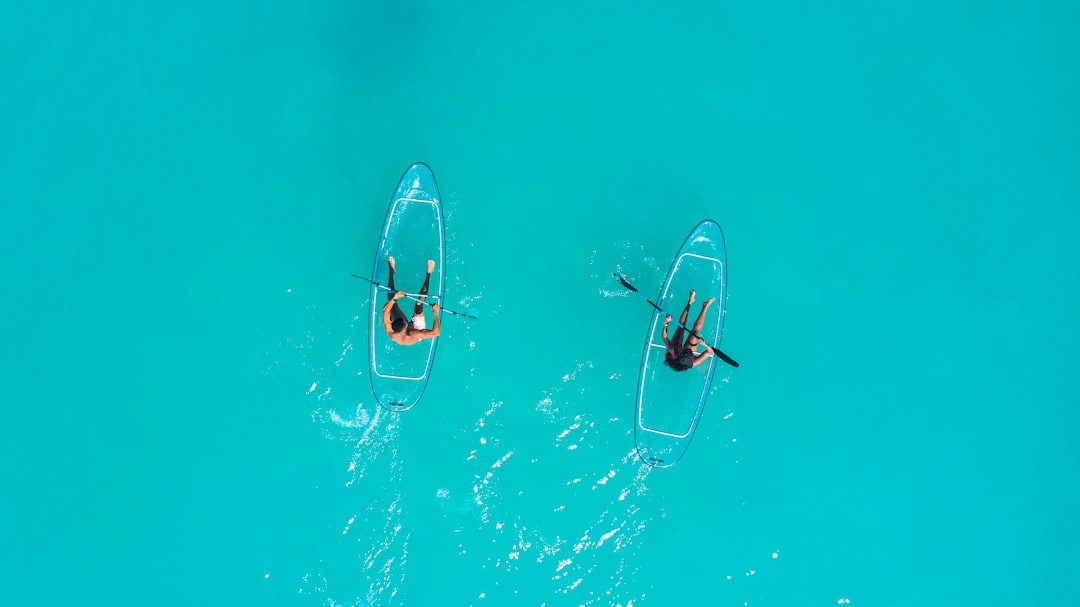 a group of people enjoying a pontoon boat on clear blue water