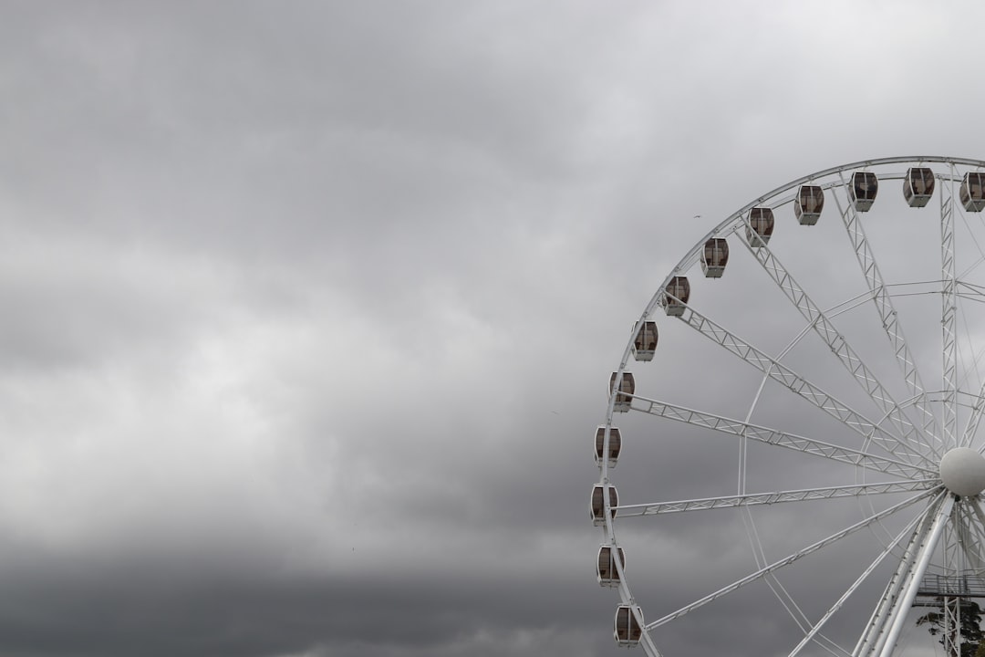colorful Ferris wheel against a moody stormy sky