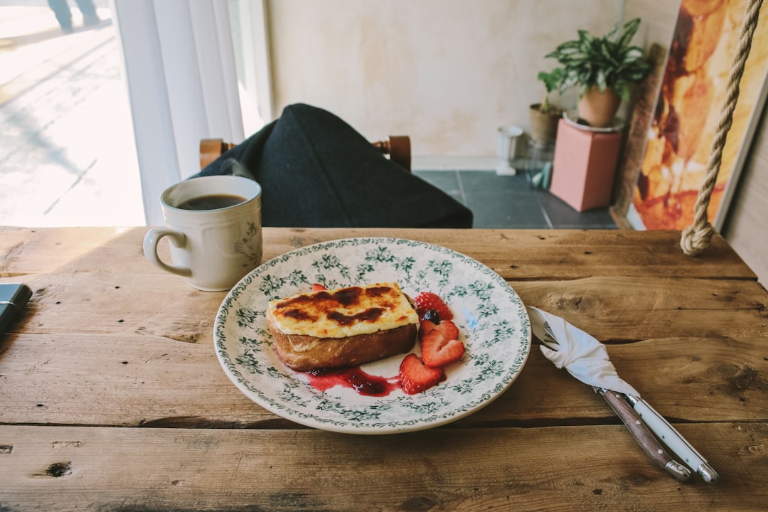 delicious plate of french toast with berries and syrup at a brunch cafe