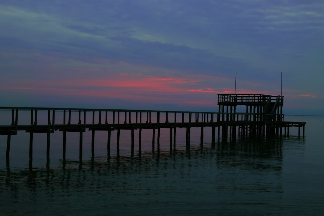 fishing pier stretching into the Gulf of Mexico at sunset