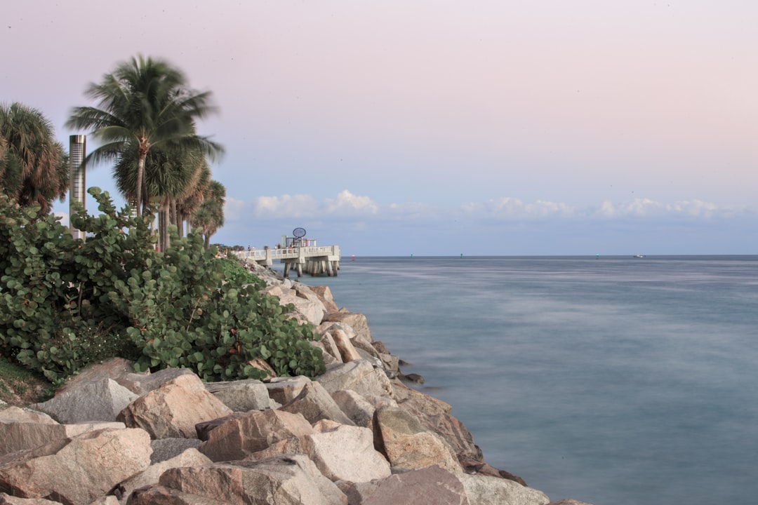 large rock jetty extending into turquoise ocean water in Florida