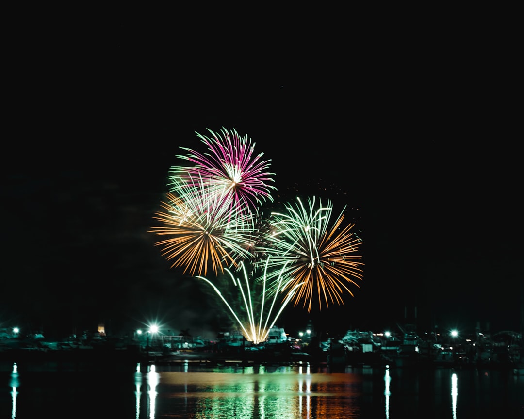 Panama City Beach pier at night with fireworks exploding overhead