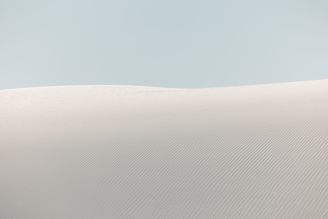white sand dunes with sea oats and clear turquoise water