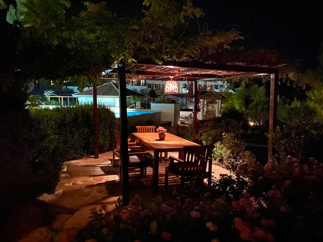 beautiful outdoor patio at a vacation rental with a grill and dining table at twilight
