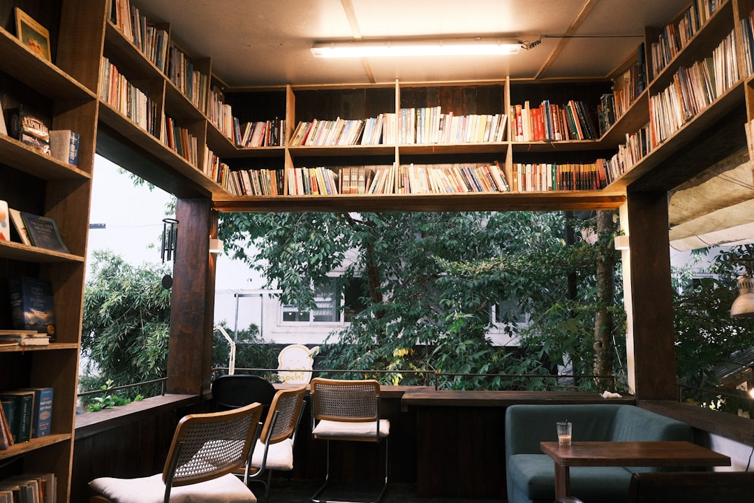 cozy independent coffee shop interior with bookshelves and armchairs
