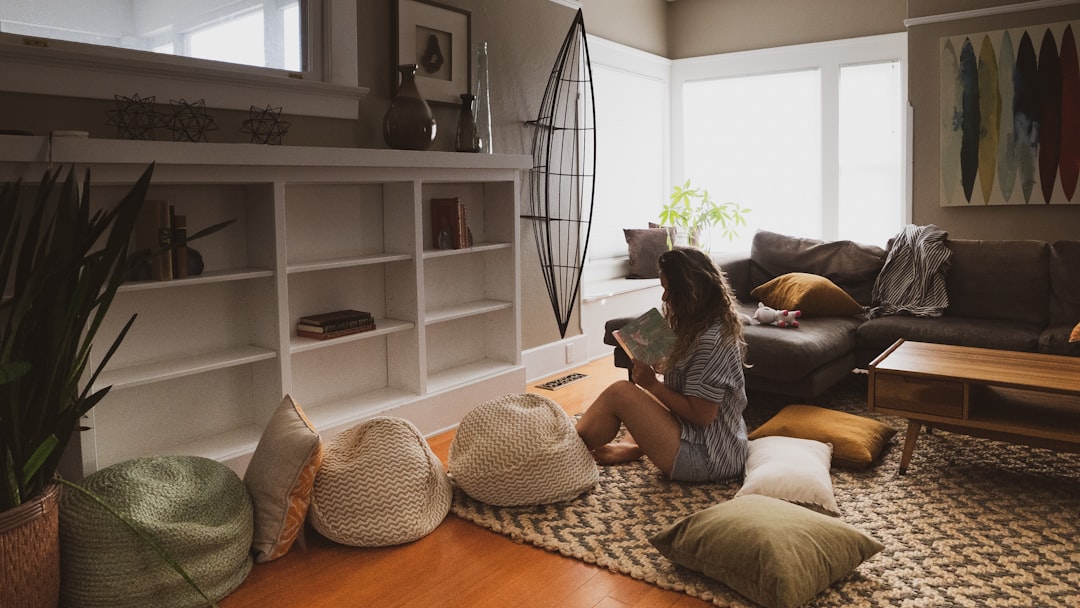 interior designer arranging pillows on a modern sofa