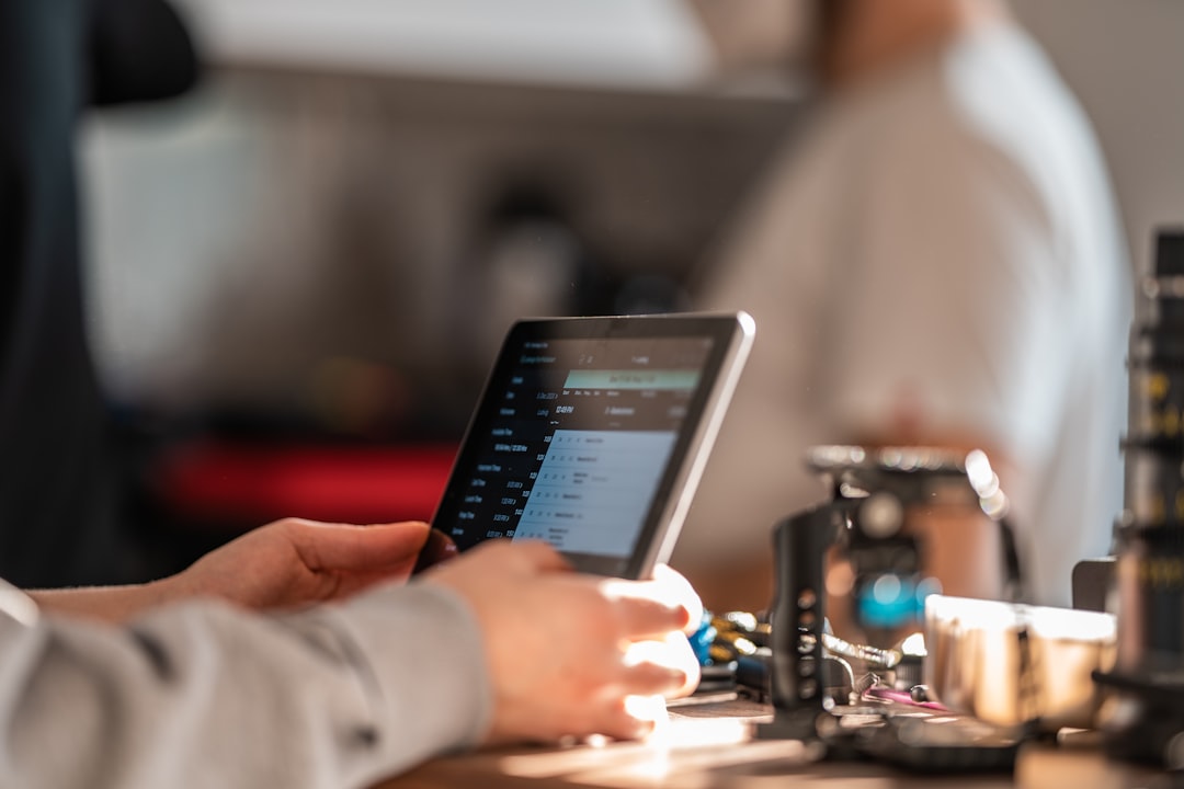 person reviewing financial charts on a tablet screen