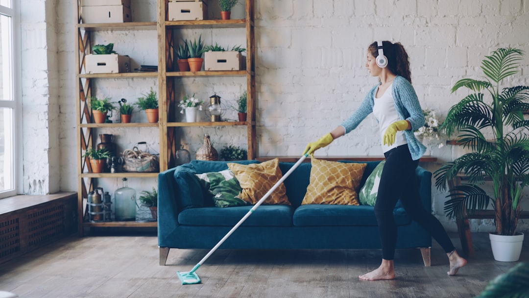 professional cleaner with a cart of supplies in a modern home