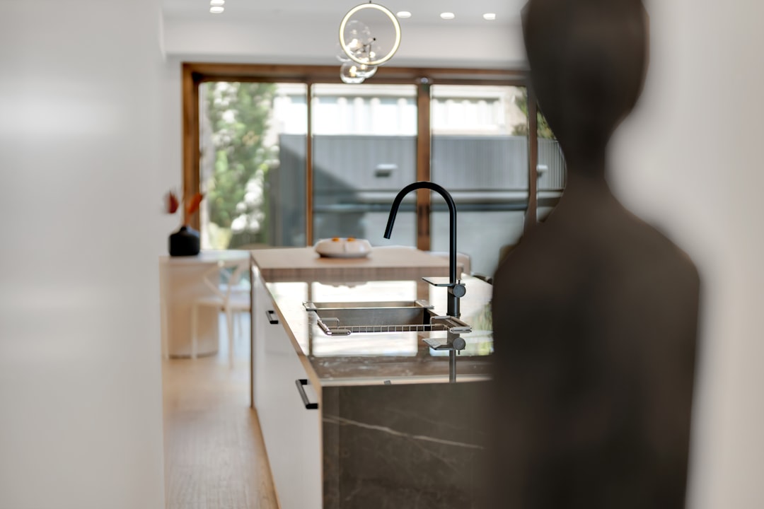 professional real estate photographer taking picture of a modern kitchen