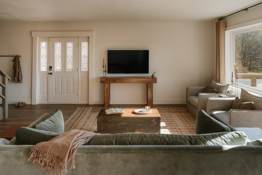 stylish living room with a tablet on the coffee table displaying a welcome screen