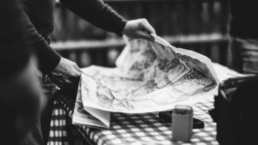 a person looking at a map with a cup of coffee