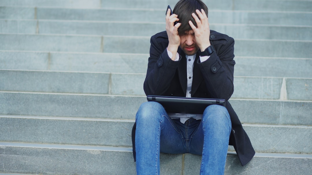frustrated traveler looking at hidden fees on a laptop screen