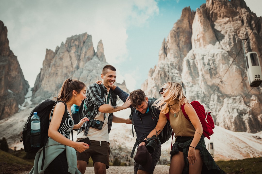 group of friends planning a trip around a laptop