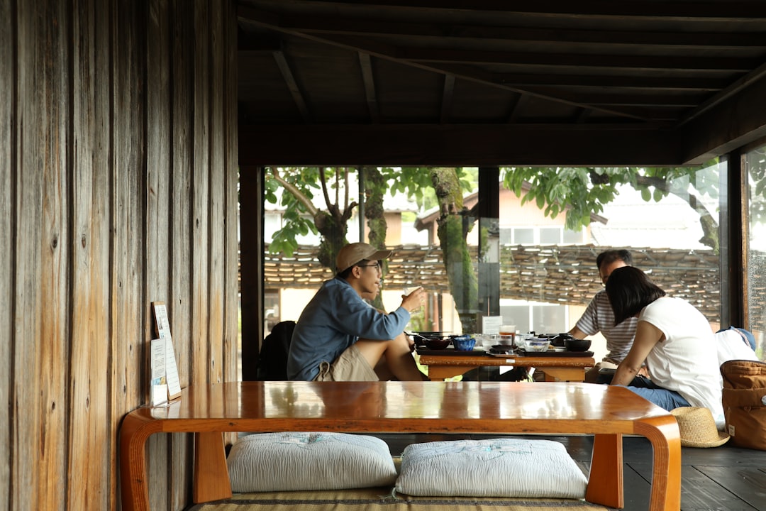 group of friends playing board games around a large wooden table