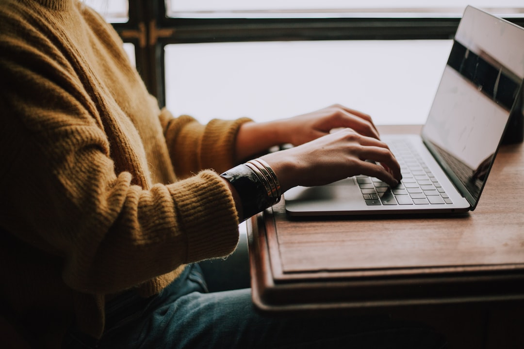 person typing into a search bar on a laptop