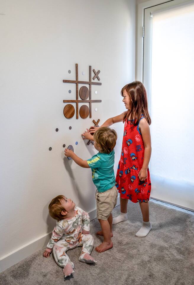 A cozy living room with a fireplace and large windows showing mountain views.